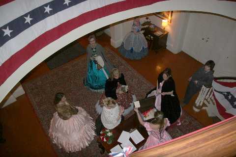 Guests arriving at the foot of the Grand Staircase at the Executive Mansion.